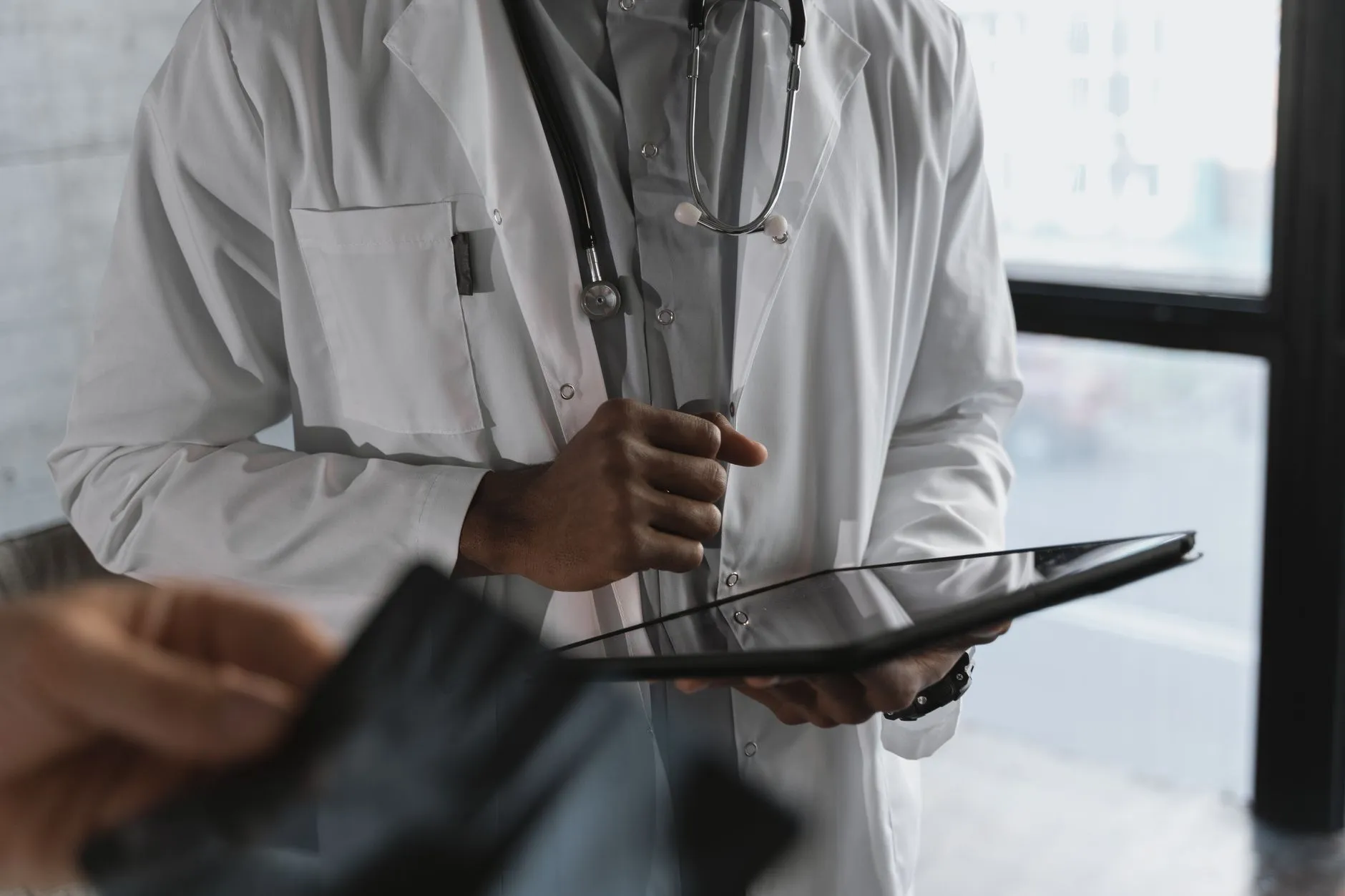 A clinician holding a tablet.