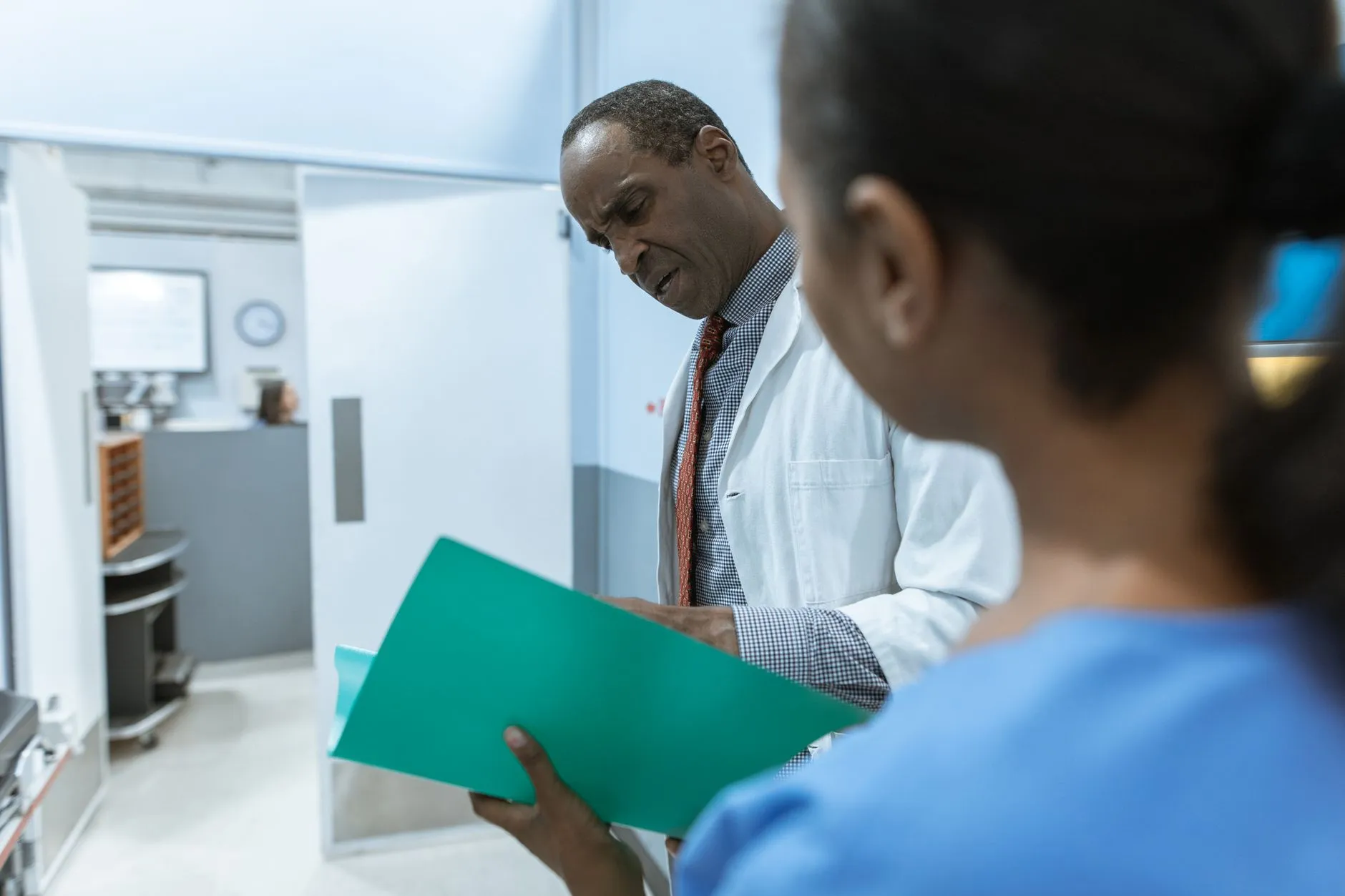 Two clinicians reviewing a folder together.