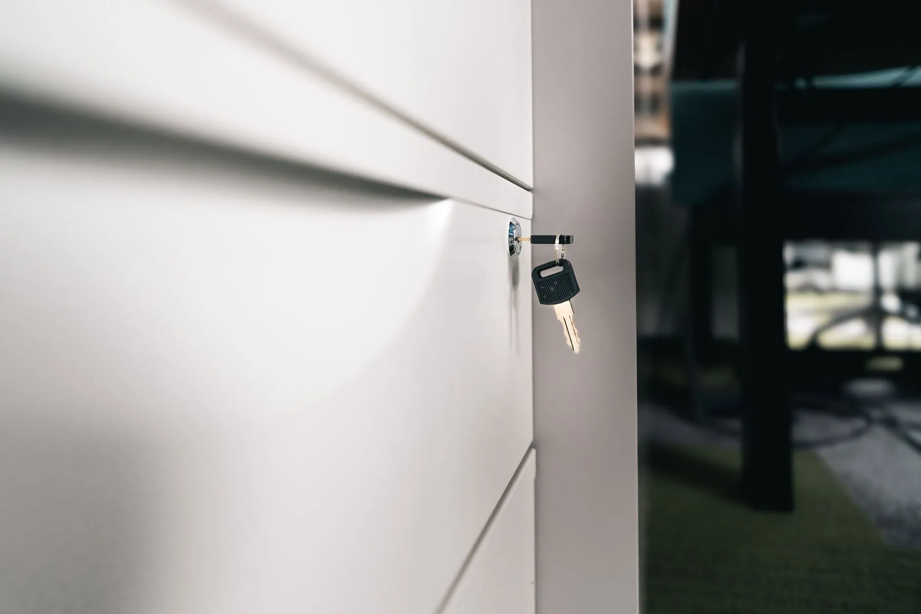 A key left in the lock of an office drawer.