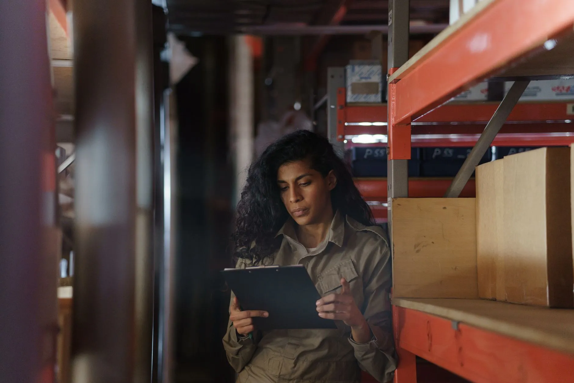 A person taking inventory with a clipboard.