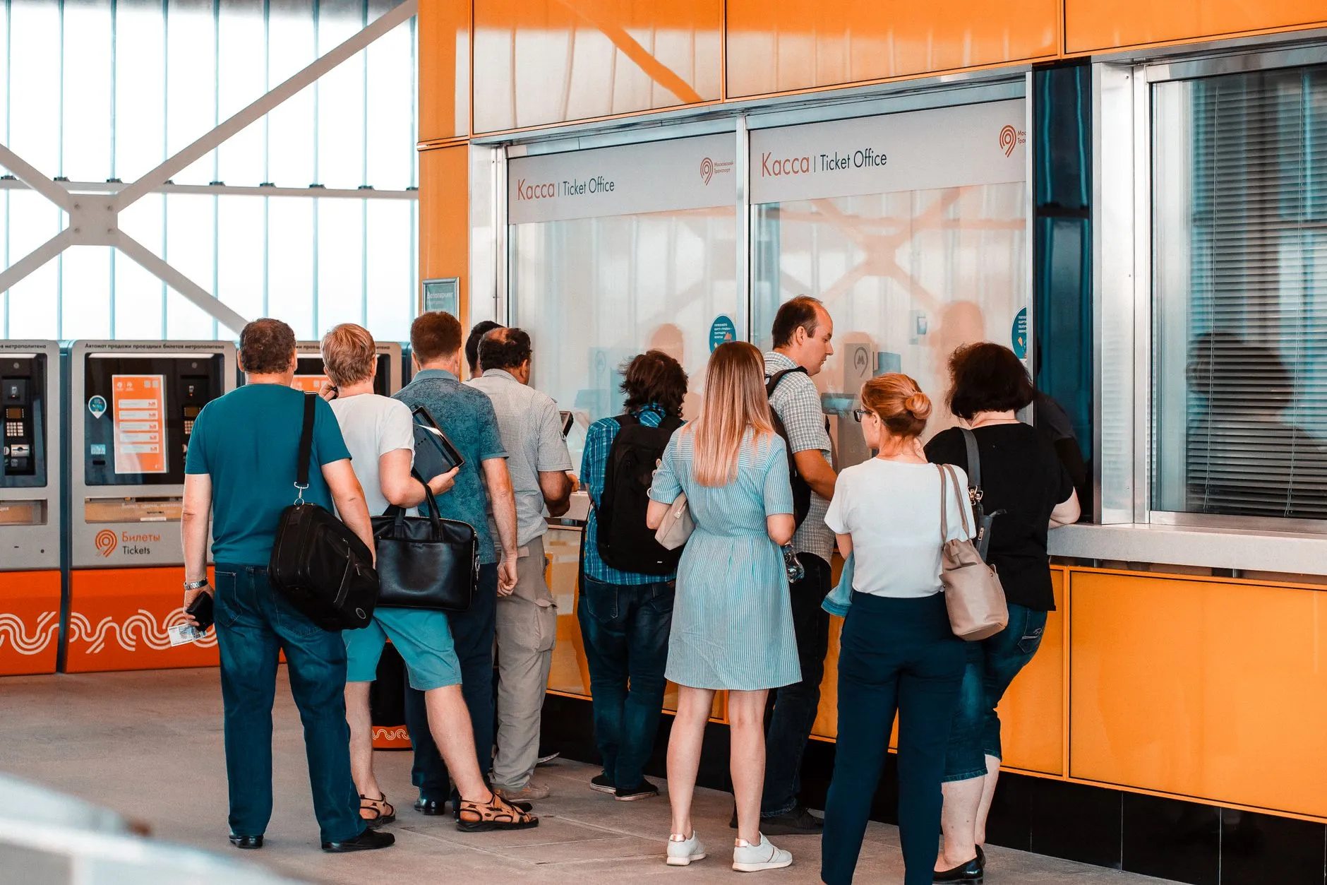 People standing in a queue at a counter.